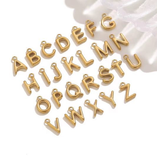 Gold letter charms on a white background