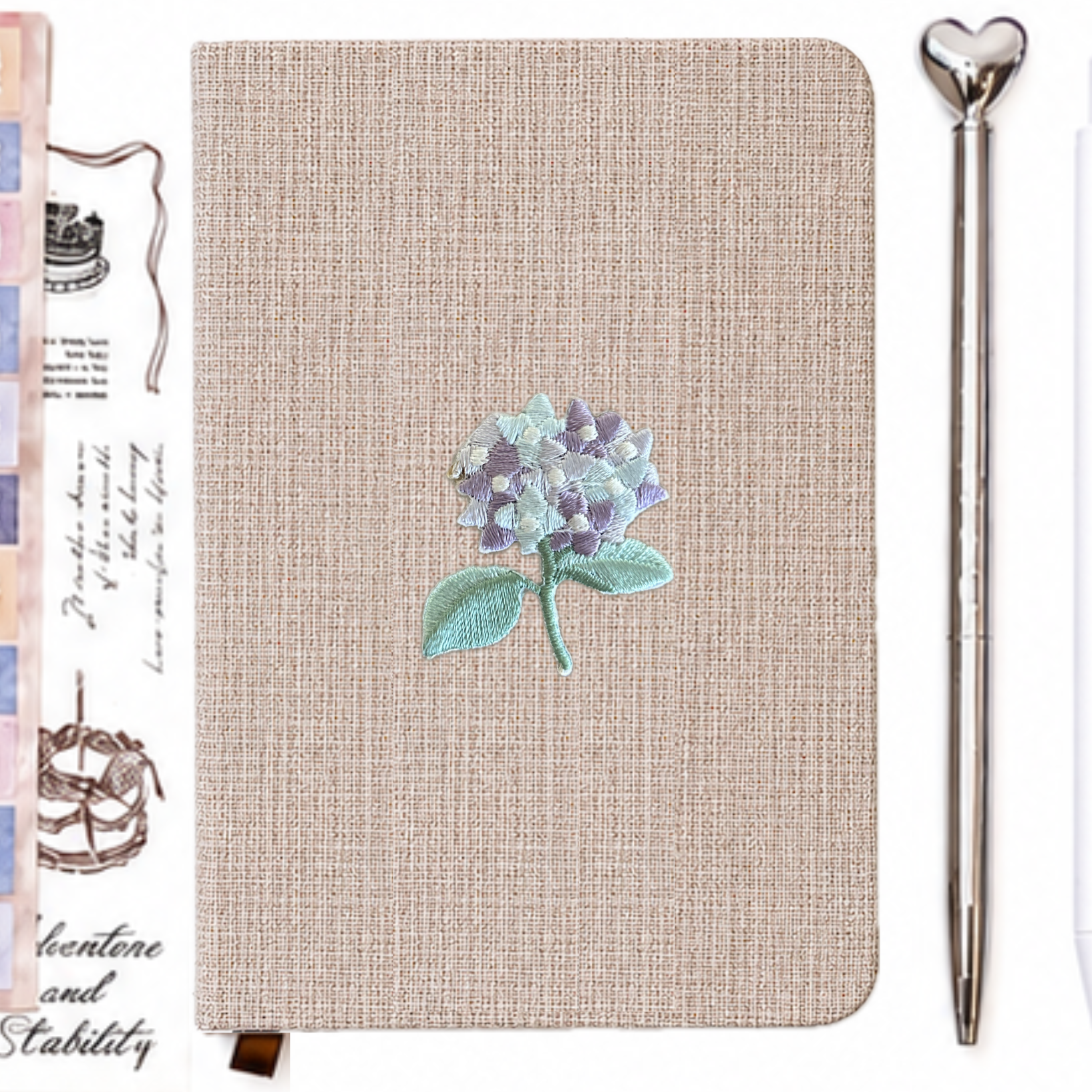 Beige linen notebook with lavender hydrangea embroidery, silver heart pen and aesthetic stationery accessories