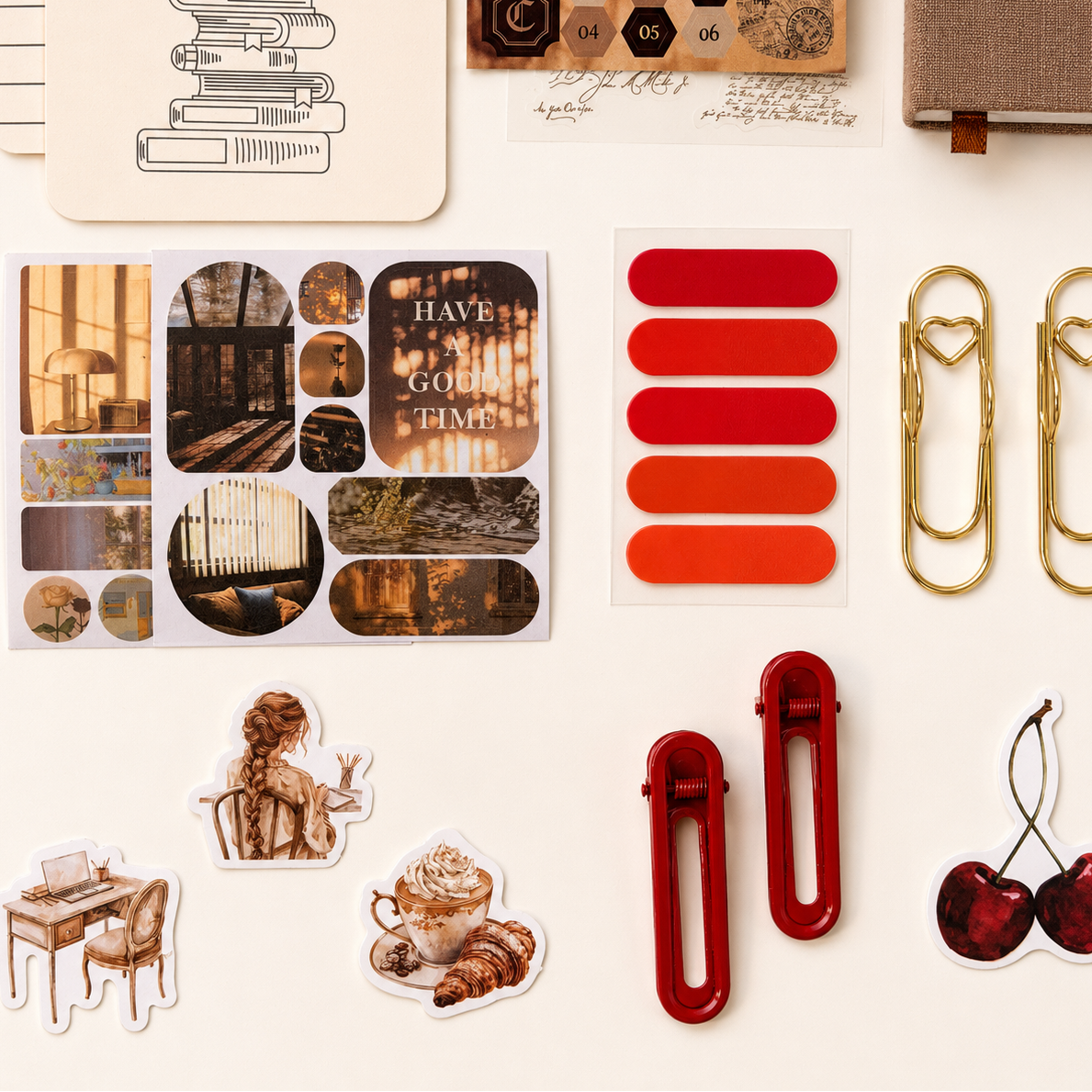 Collection of stationery items including stickers, clips, and paperclips on a light background