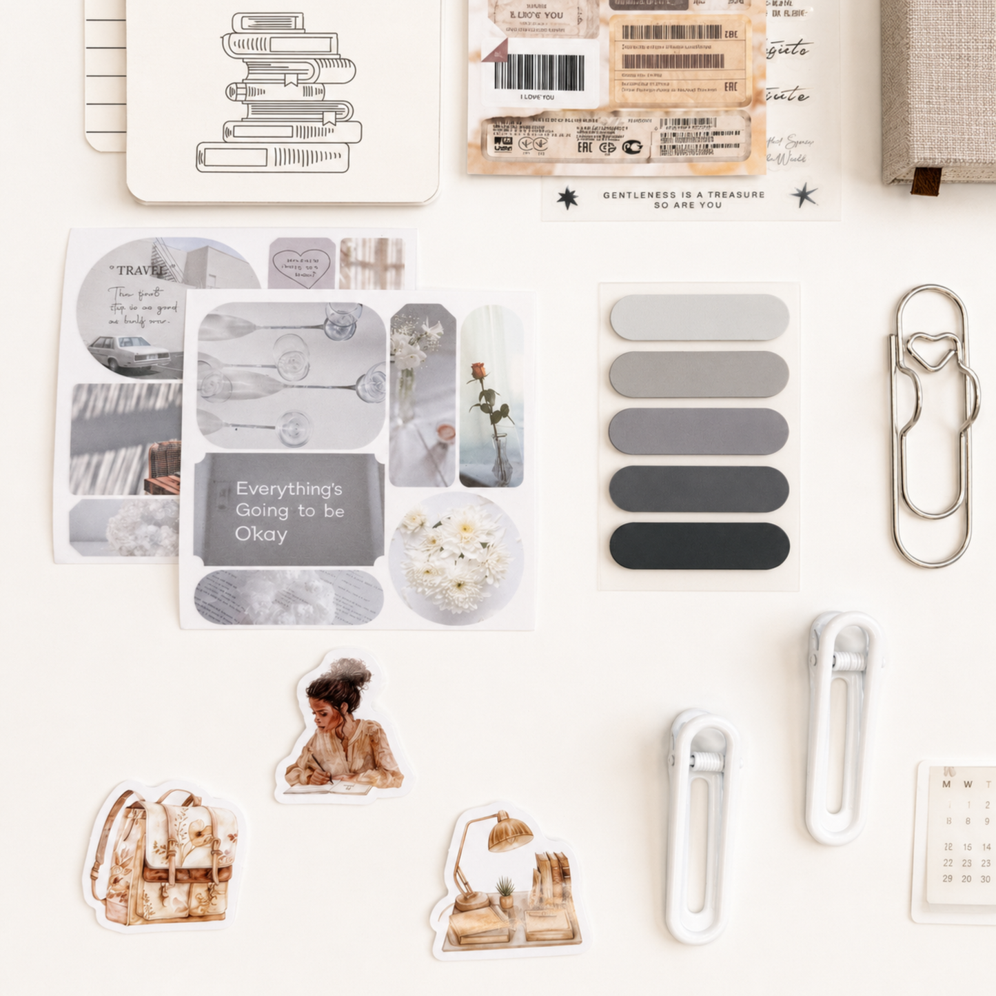 Neutral aesthetic stationery accessories with gray-toned stickers, minimalist page tabs, oversized paper clips and cozy journaling details in a soft vintage palette
