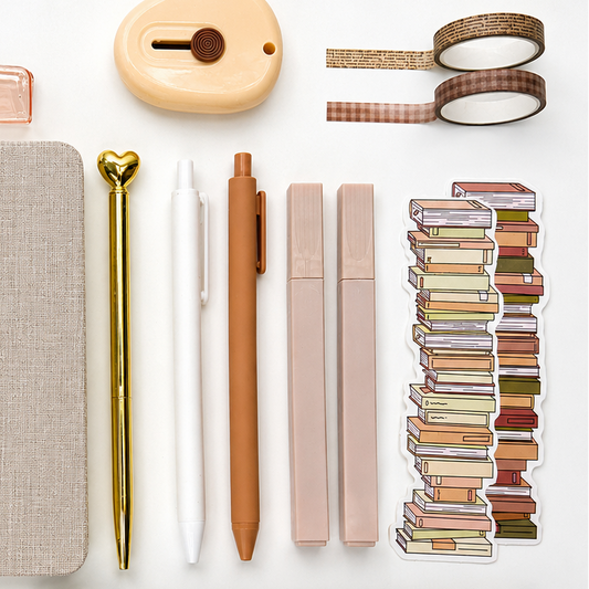 Neutral aesthetic stationery accessories with pastel pens, washi tape, mini label maker and stacked book sticker