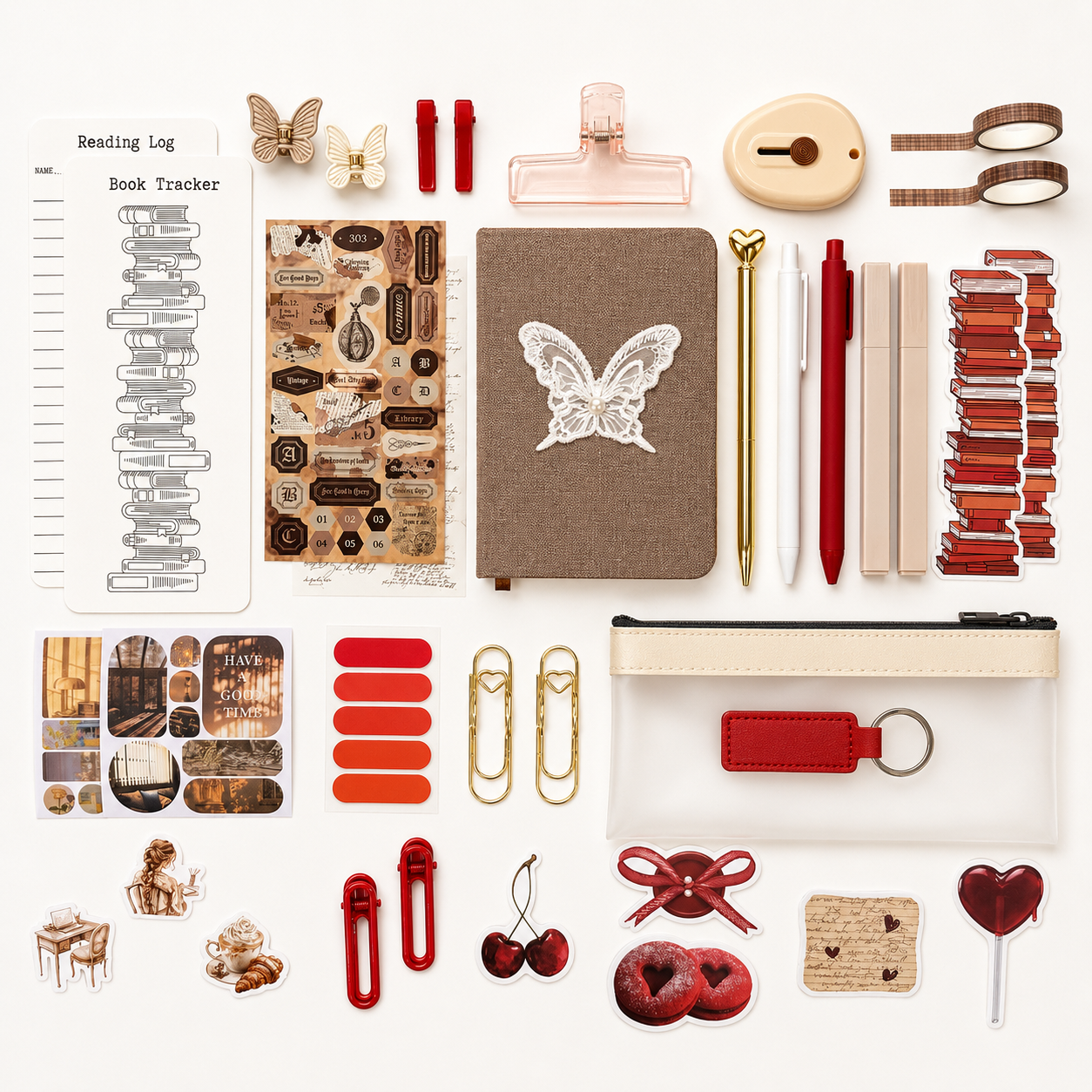 Collection of stationery items including a notebook, stickers, and clips on a white background