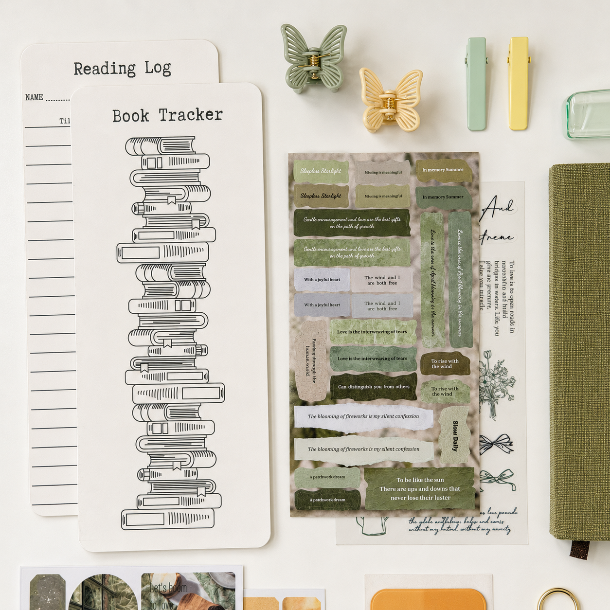 Green aesthetic stationery set with reading tracker, vintage journaling stickers, butterfly clips and cozy linen notebook flat lay