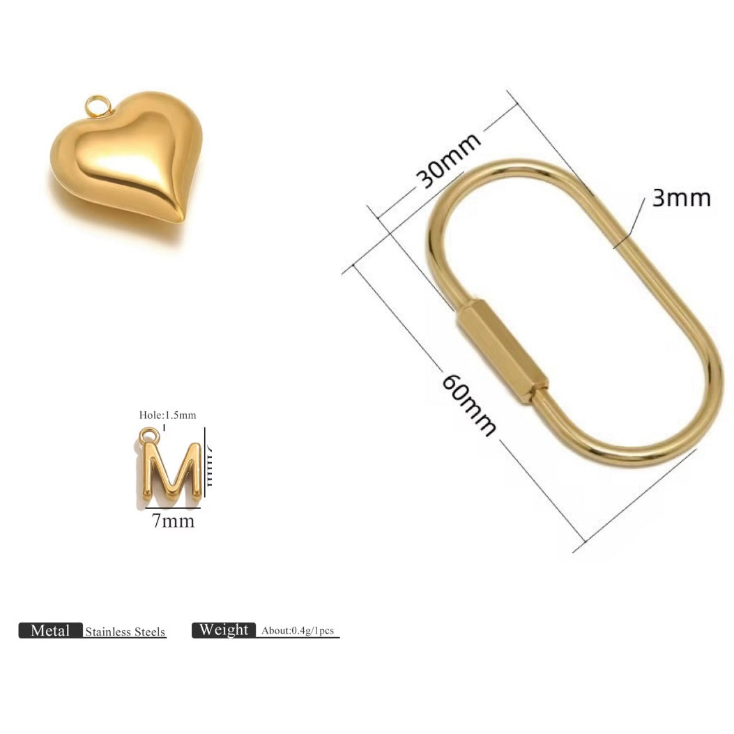 Gold heart-shaped pendant and keychain with measurements on a white background