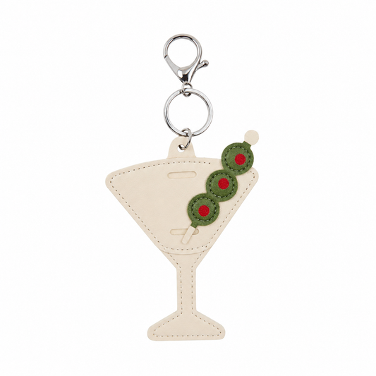Keychain shaped like a martini glass with olives on a white background