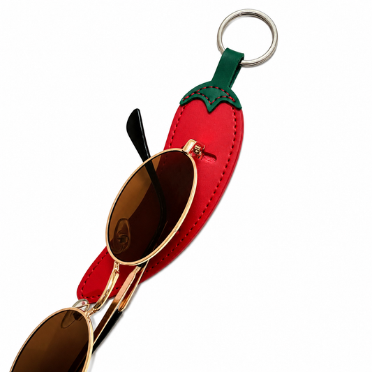 Red chili pepper-shaped keychain with sunglasses on a white background
