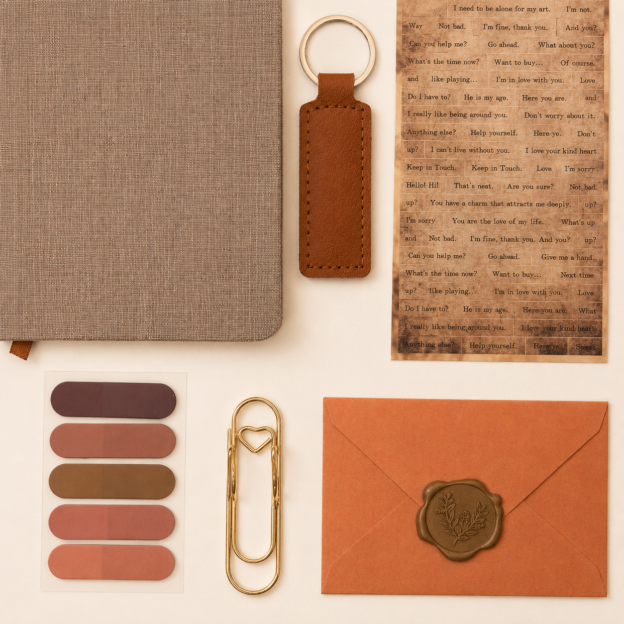 Collection of brown stationery items including a notebook, keychain, envelope, and paper clips on a beige background.