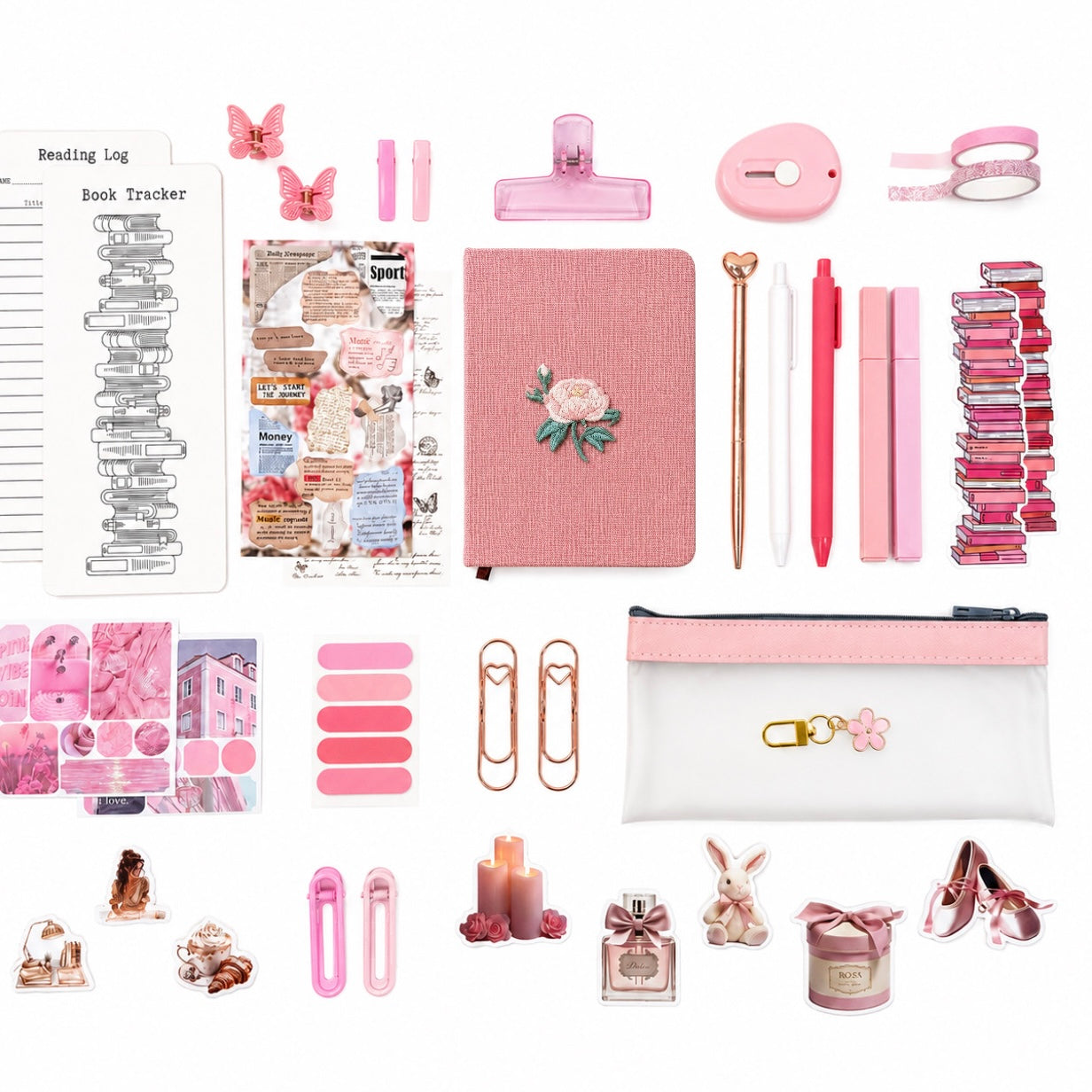Collection of pink stationery items including a notebook, clips, and decorative elements on a white background.