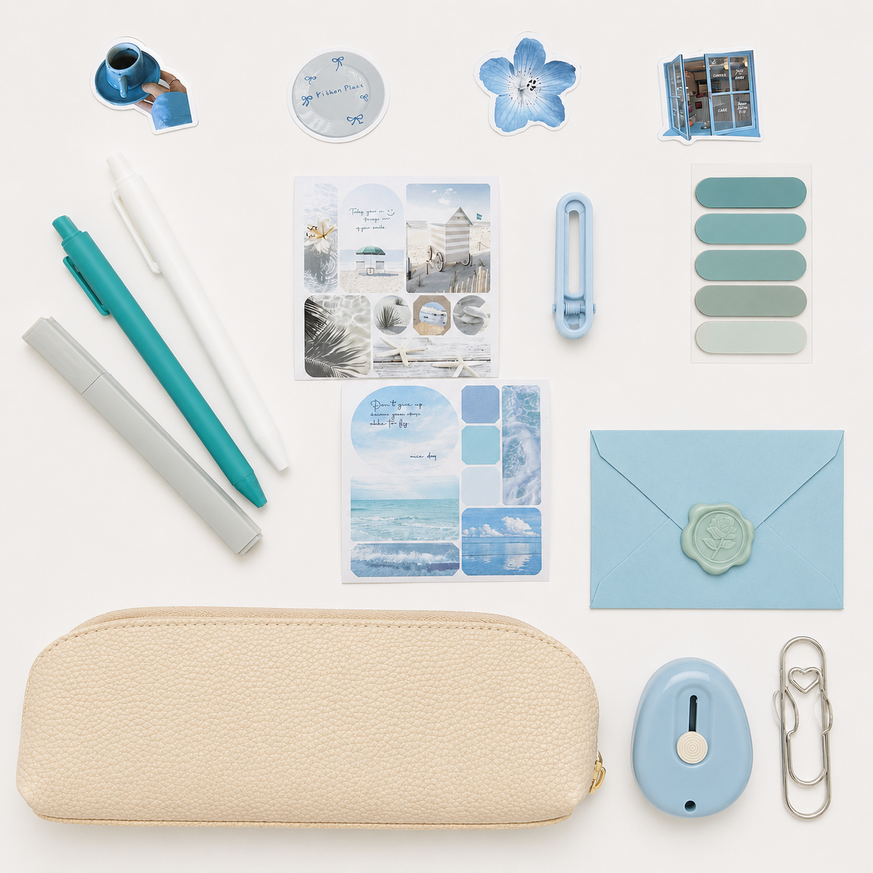 Collection of stationery items including pens, cards, and a pouch on a white background