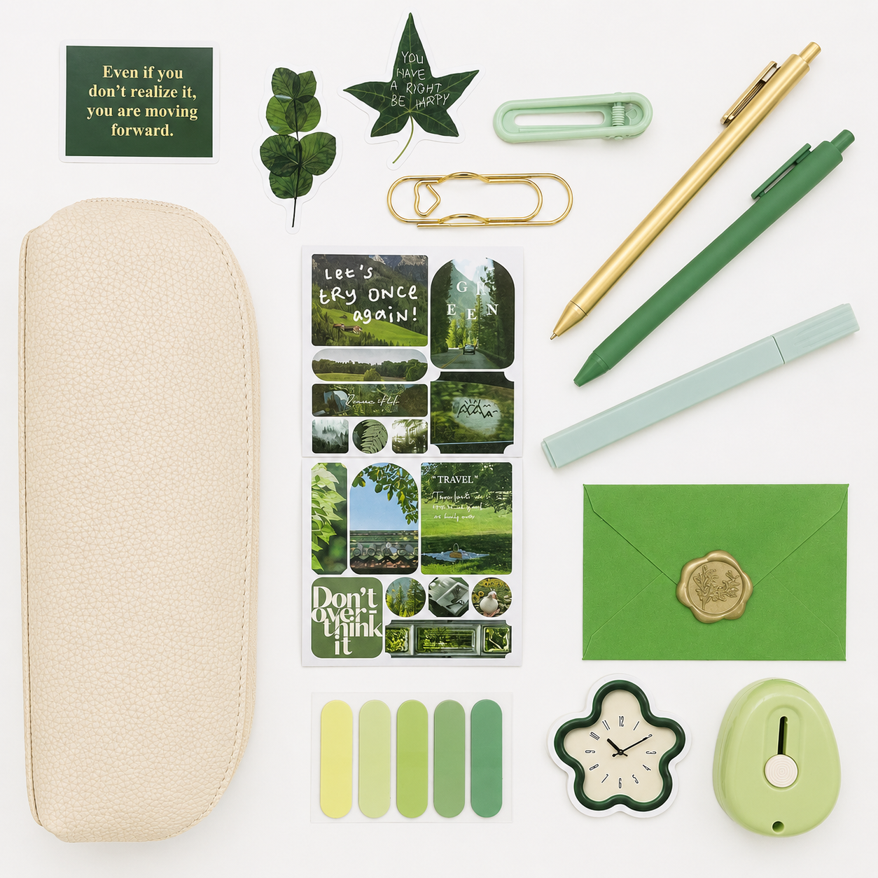 Collection of stationery items including pens, stickers, and a clock on a white background