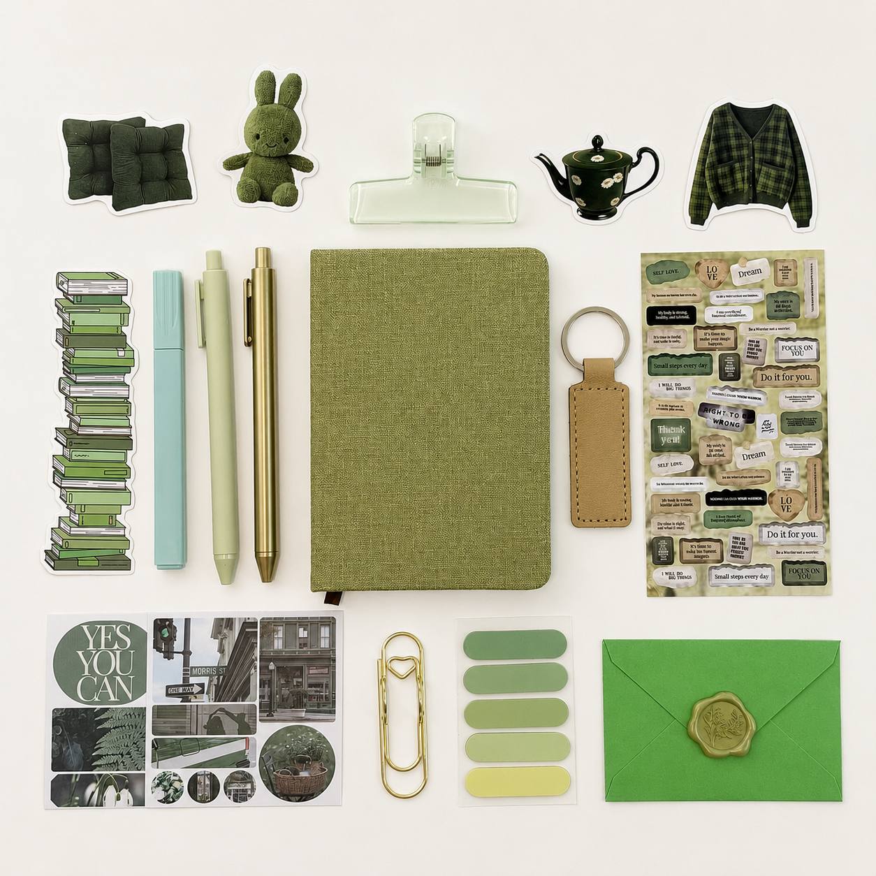 Collection of green stationery items on a white background